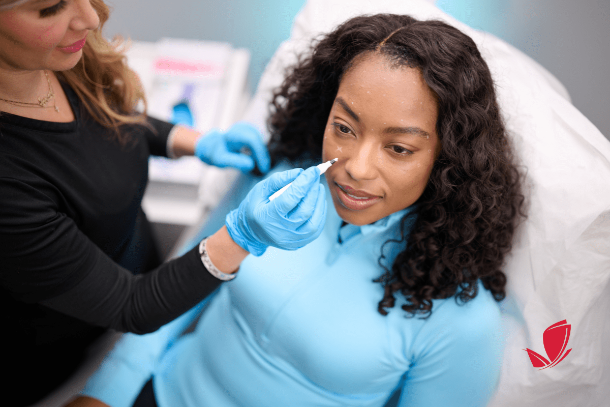 women receiving a consultation for Botox treatments on her face.