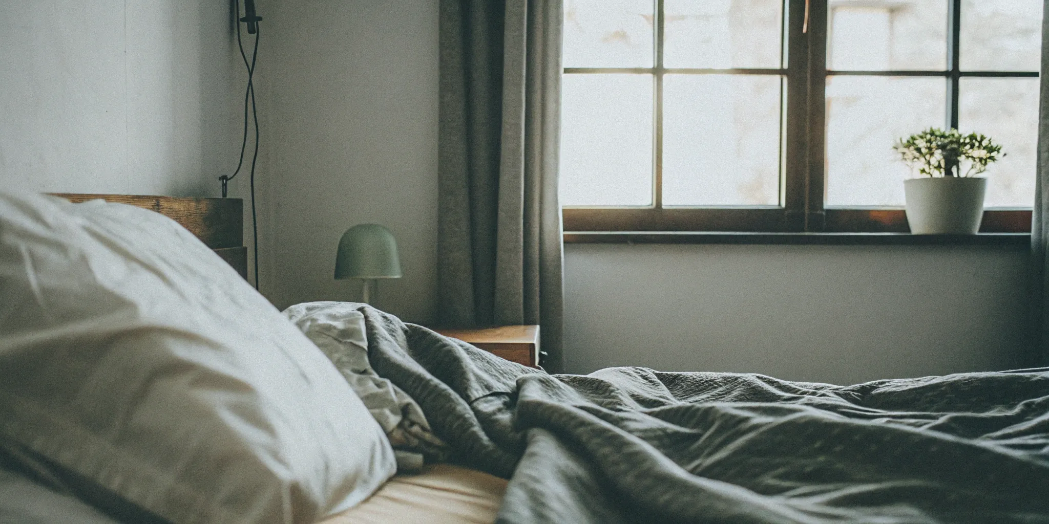 A bed with pillows arranged to prevent sleeping on your side after Botox.