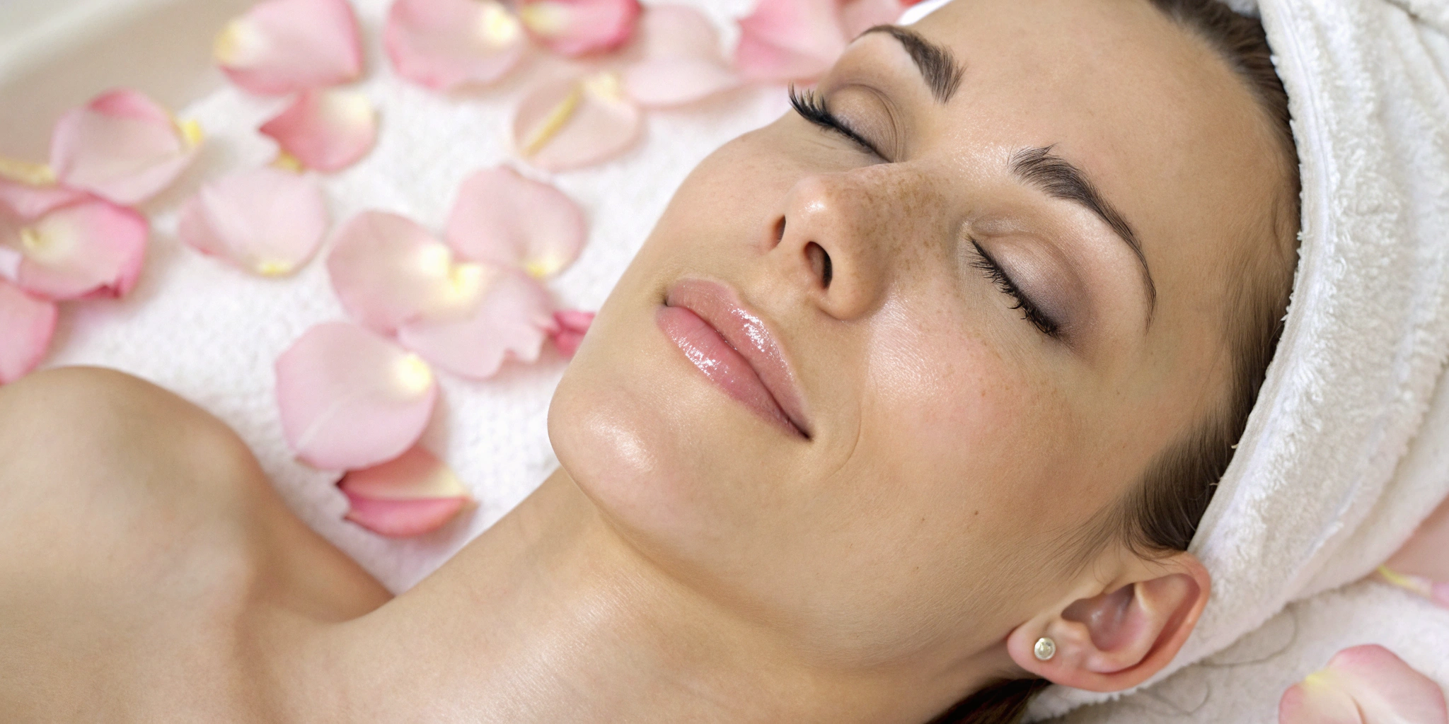 Woman with clear, glowing skin relaxing after a skin rejuvenation treatment.