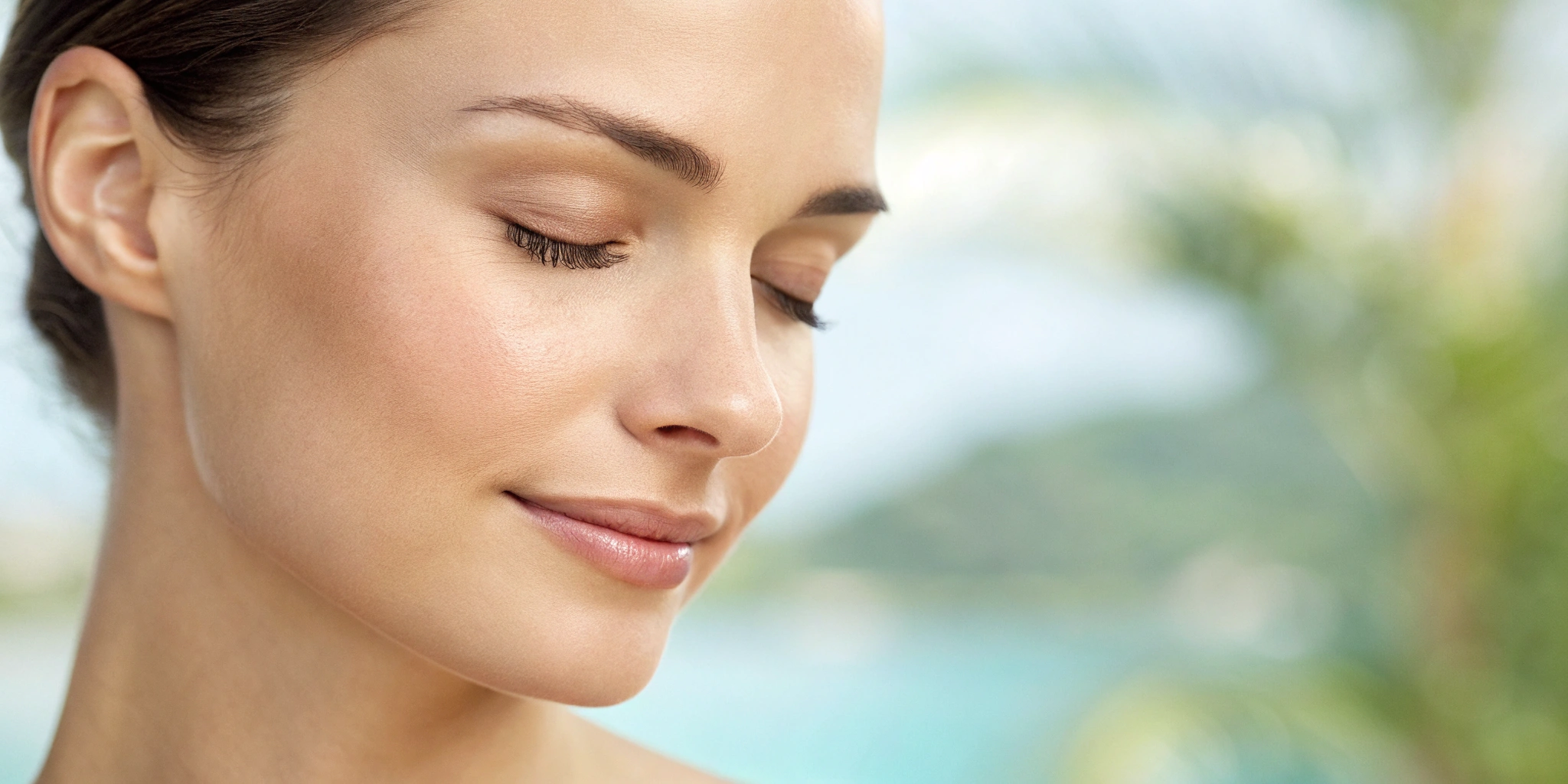 Woman with smooth, youthful skin and a firm jawline after facial skin tightening treatments.